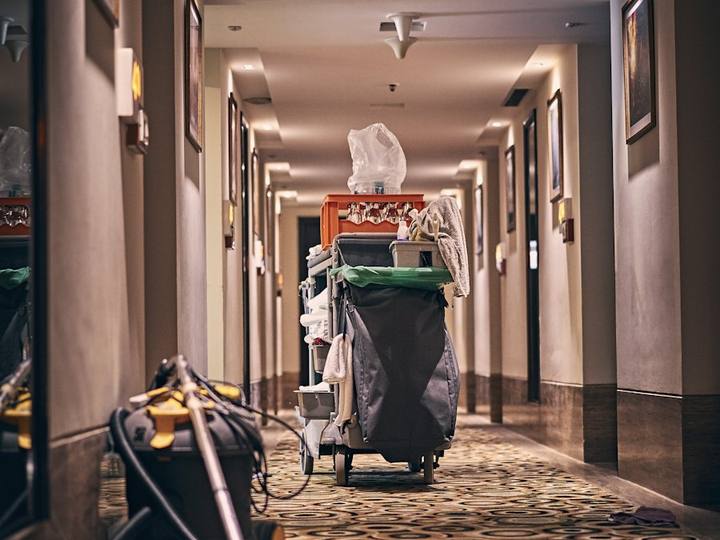 Cleaning trolley and vacuum in a carpeted corridor